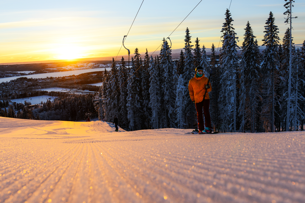 Nypistad skidbacke med skidåkare i liften