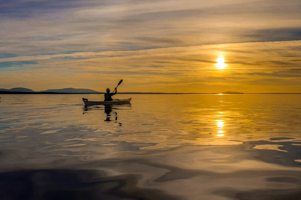 Kajakpaddling i solnedgång