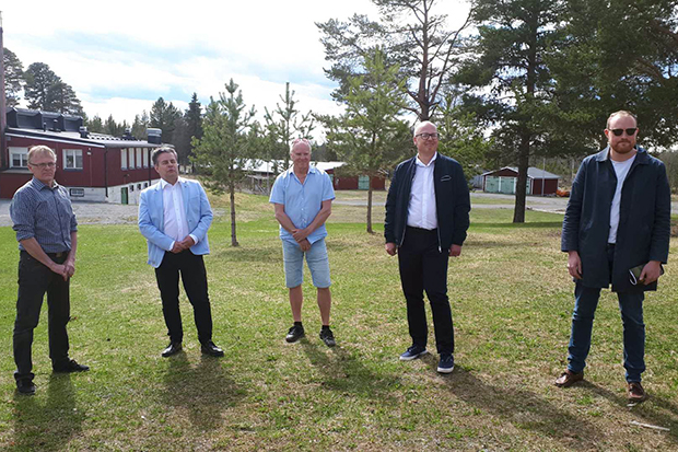 Fem män stående på gräset utanför Grytans f d flyktingförläggning.