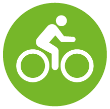 Rund grön skylt med piktogram för cykling.