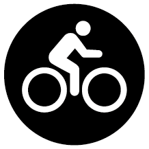 Rund svart skylt med piktogram för cykling.