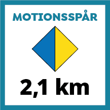 Skylt för motionsspår på 2,1 km med tvåfärgad romb i blått och gult. Färgerna indikerar dels längden på spåret samt att spåret har belysning.