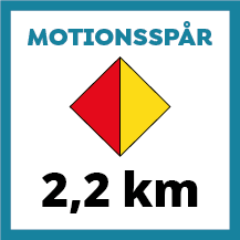 Skylt för motionsspår på 2,2 km med tvåfärgad romb i rött och gult. Färgerna indikerar dels längden på spåret samt att spåret har belysning.