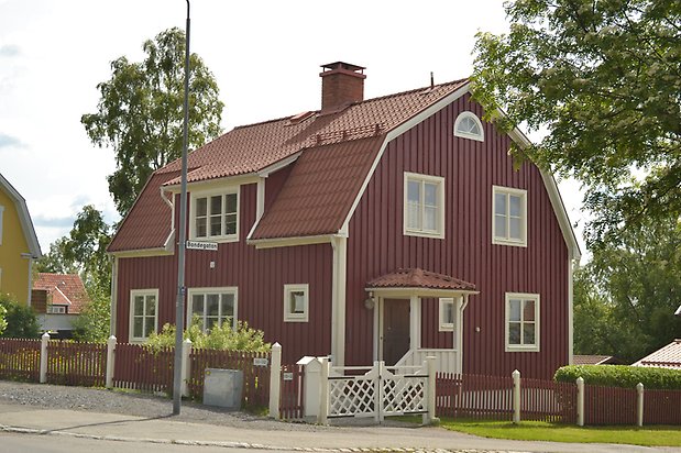 Rödingen 1, Villa i röd träpanel med vita fönster med spröjs, takkupa och tegeltak.