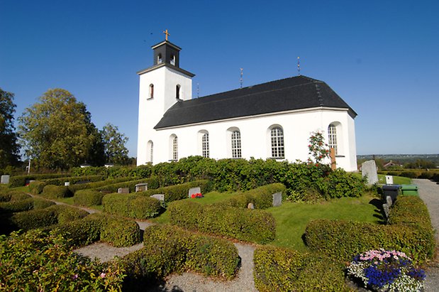 Oldberg 1:7. Kyrka i vit puts med svart tak. 