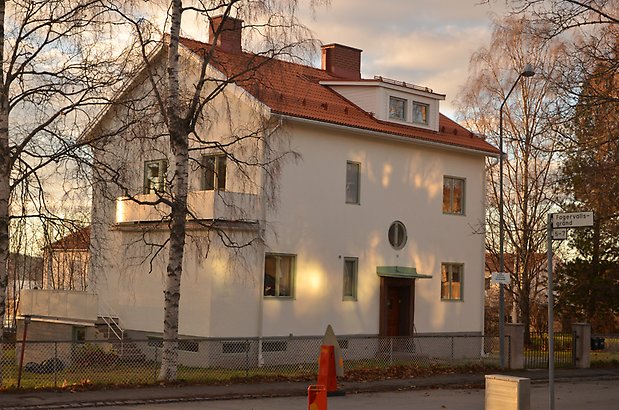 Elritsan 3. Villa i vit puts med gröna fönster och rundad balkong.