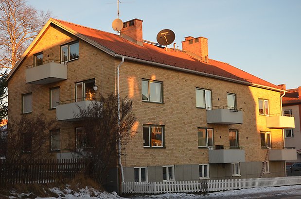 Landssekretereraren 10. Bostadshus i fyra våningar i gult tegel med vita balkonger.