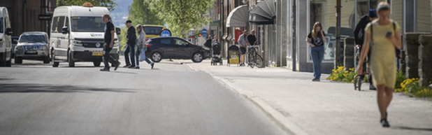 En asfalterad gata och en trottoar med marksten