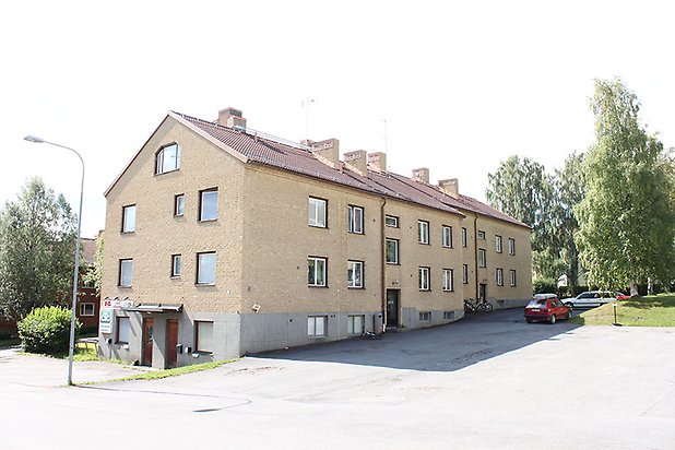 Söre 2:98. Flerbostadshus i fyra våningar i gult tegel, bottenvåningen har lokaler.